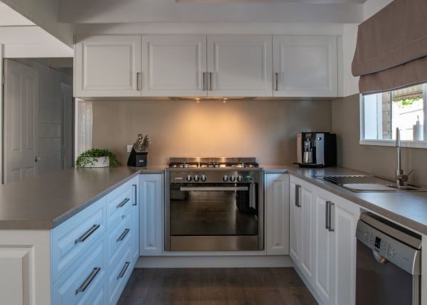 Beige coloured splashback in a white kitchen