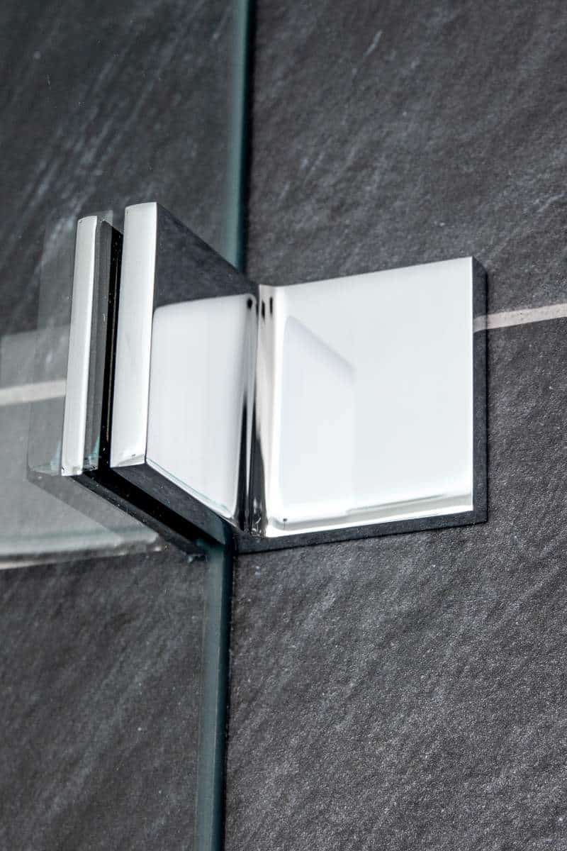 Frameless shower chrome bracket detail close-up