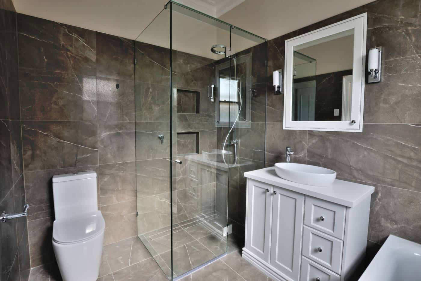 Frameless shower screen with vanity and mirror in modern bathroom