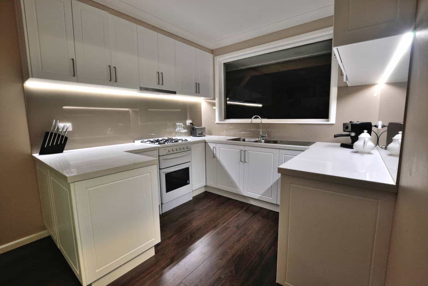 Beige glass splashback in a white kitchen in Melbourne
