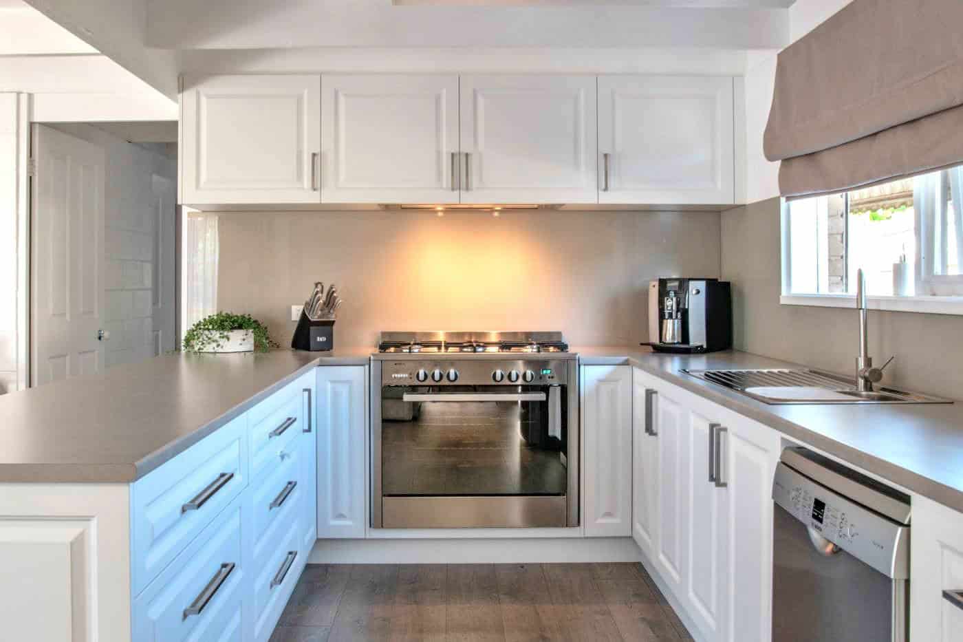 aqua-glass-splashback-off-white-kitchen Beige glass splashback and benches in a white kitchen in Melbourne