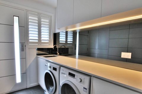 Grey mirror splashback installed in a Keilor laundry