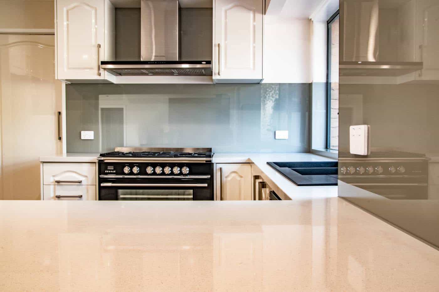 aqua-glass-splashback Mid grey glass splashback in a light kitchen in Hoppers Crossing