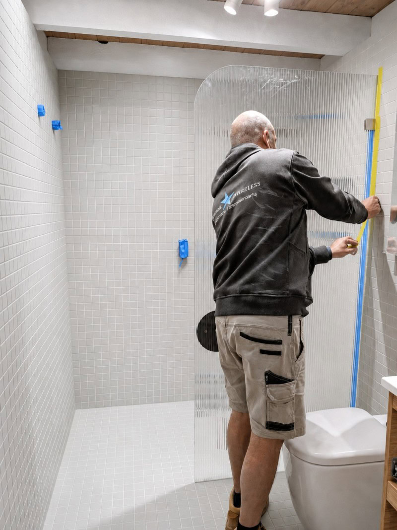 Curved glass shower screen installation in Melbourne bathroom