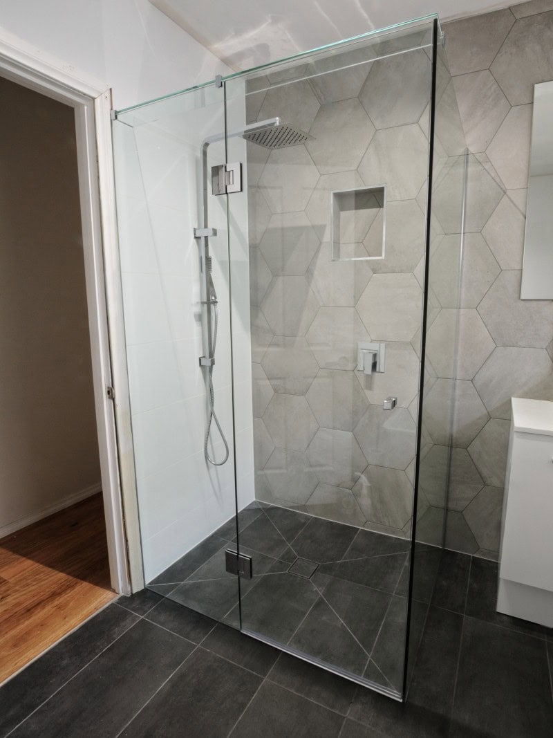 Frameless shower screen with chrome hardware installed in Mill Park