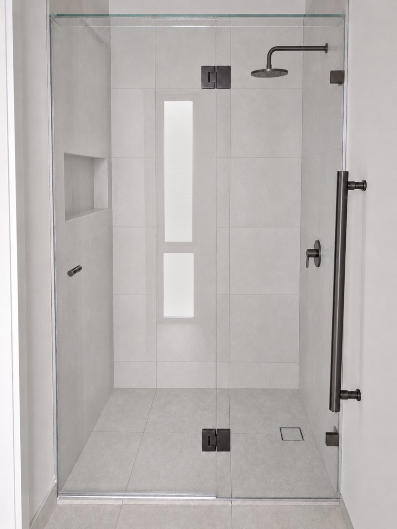 Gun metal frameless shower screen installed in Eltham bathroom