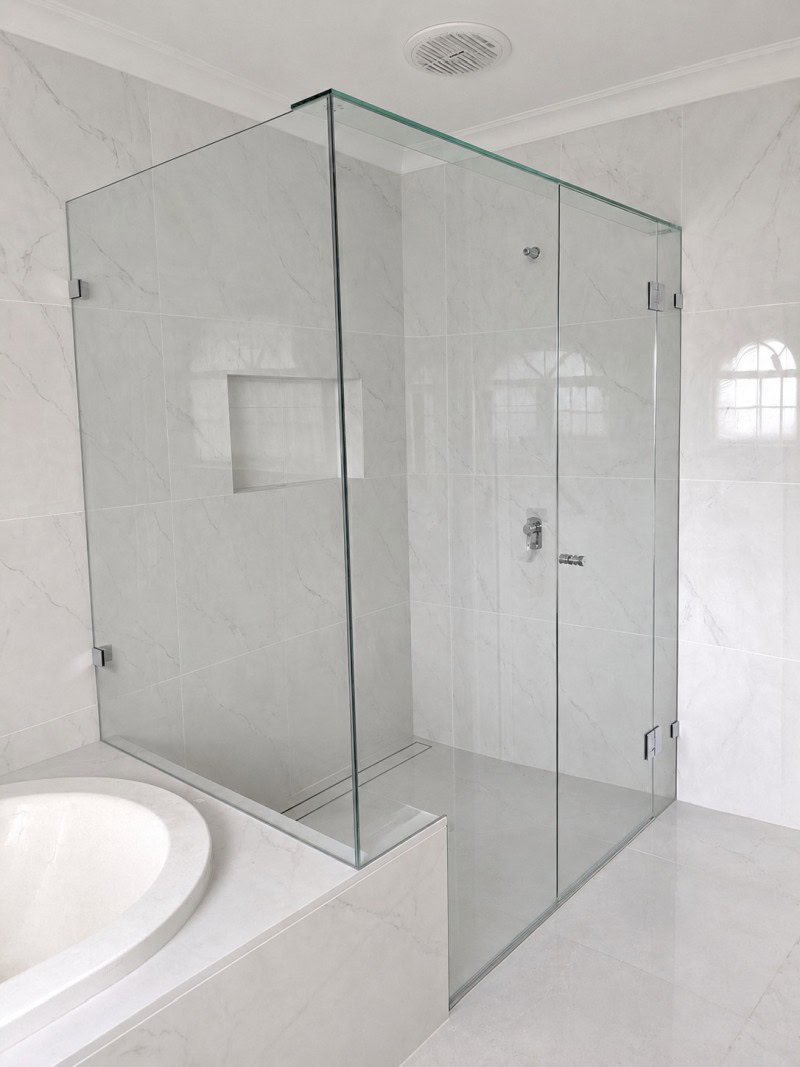 Large bathroom frameless shower screen installed in Keilor East