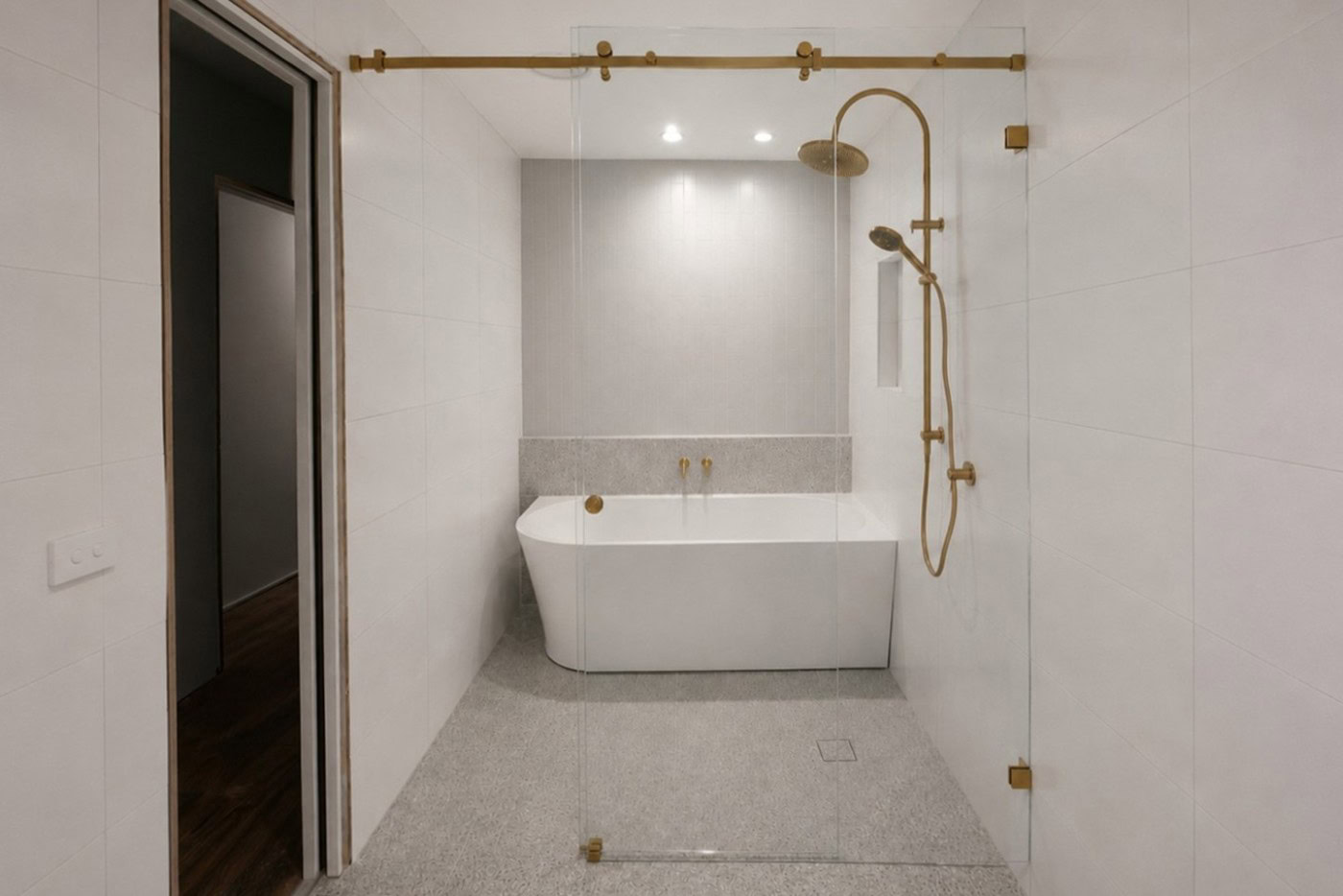 Custom frameless shower screen installed in a Maddingley bathroom