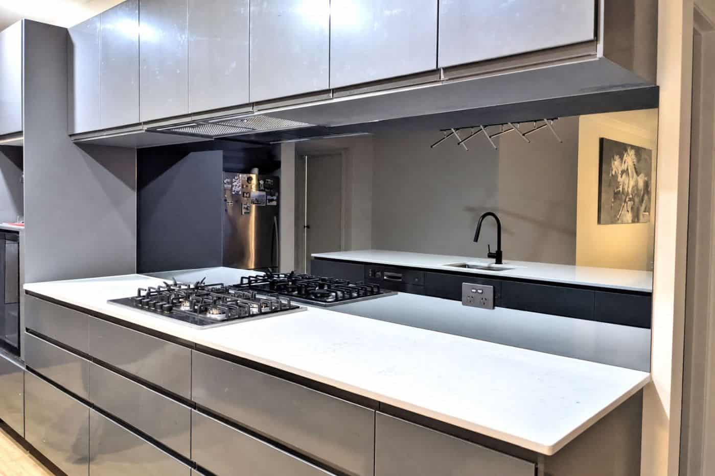 Smokey grey mirror glass splashback in a Melbourne kitchen