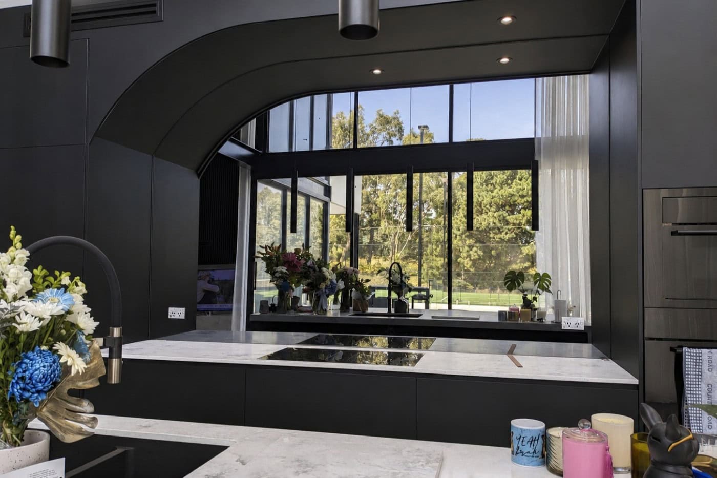 Custom smokey mirror splashback installed in Plenty kitchen