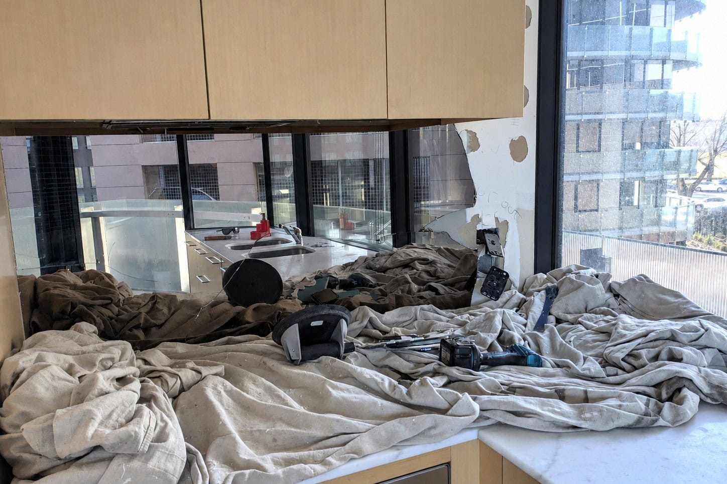 Cracked non-toughened mirror splashback before replacement in St Kilda apartment