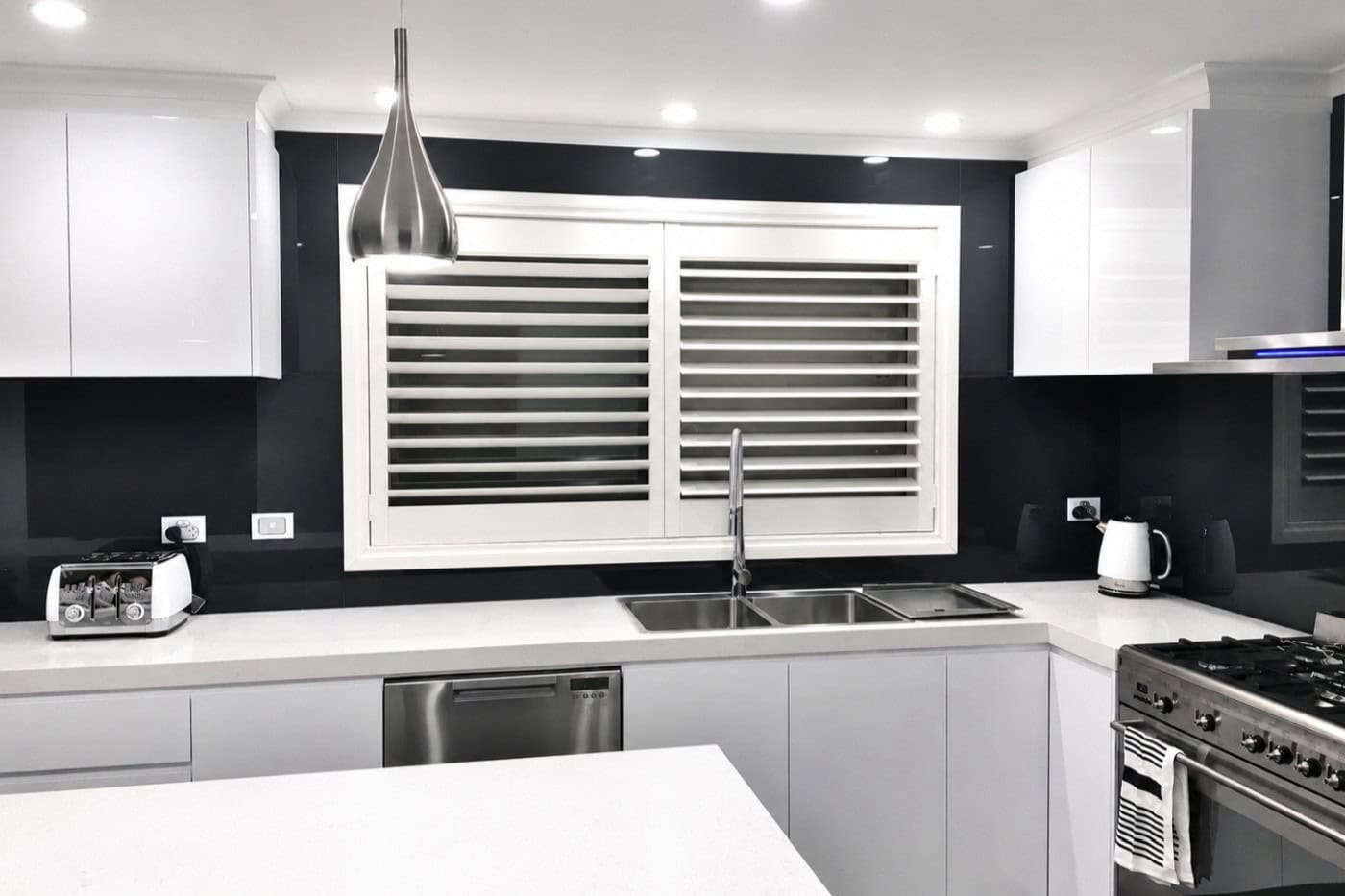 Dark charcoal grey glass splashback installed in Sydenham kitchen renovation
