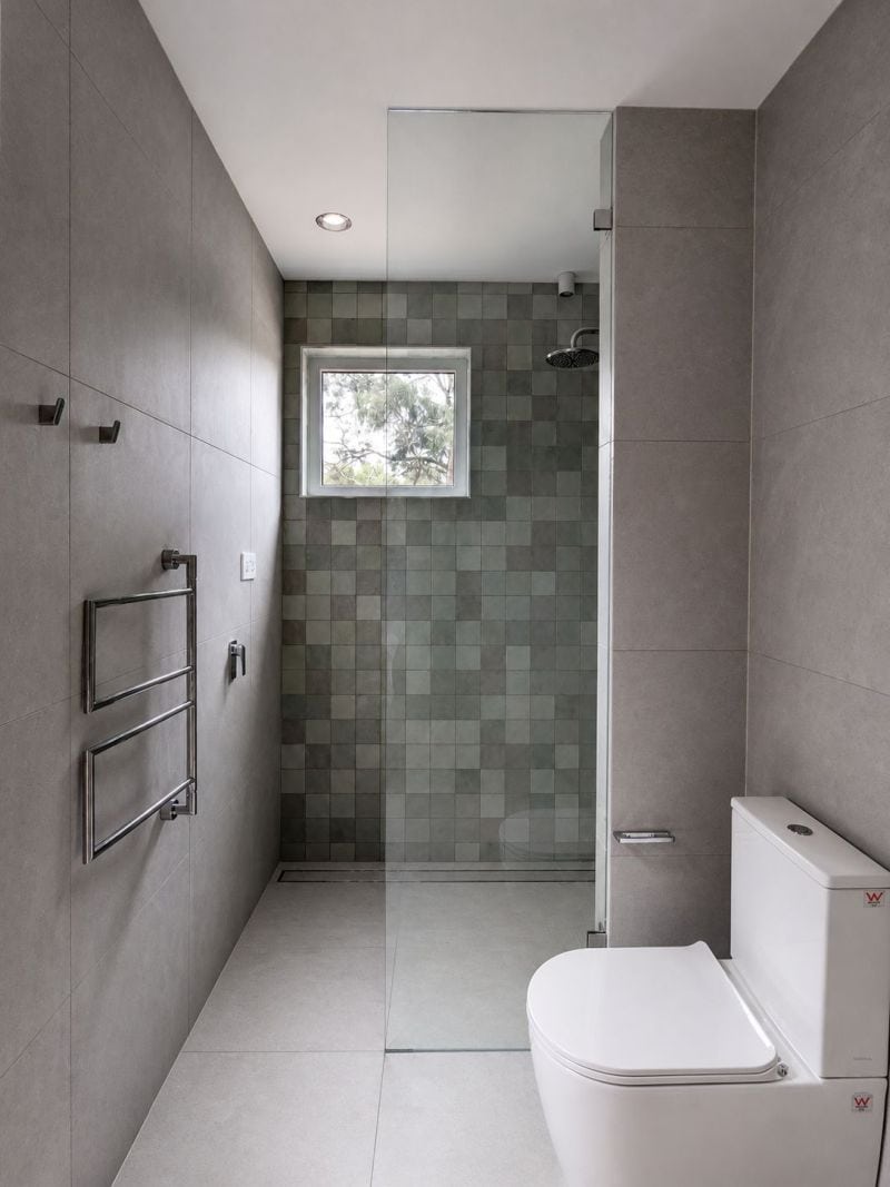 Floor to ceiling frameless shower screen in Woodend