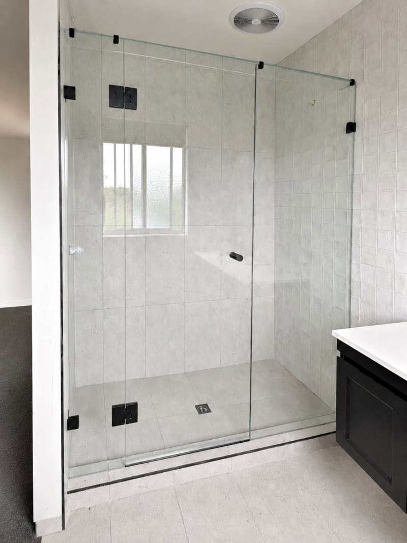 Wall to wall frameless shower screen installed in Airport West bathroom