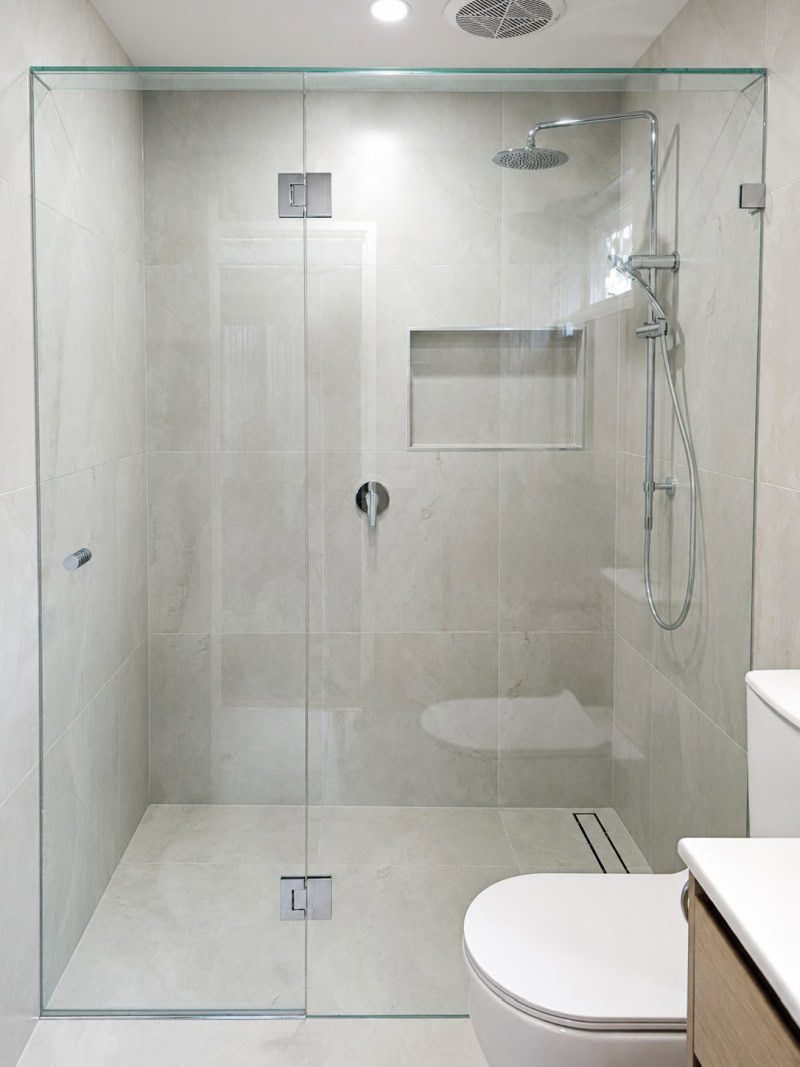 Standard clear glass hinged frameless shower screen with chrome fittings