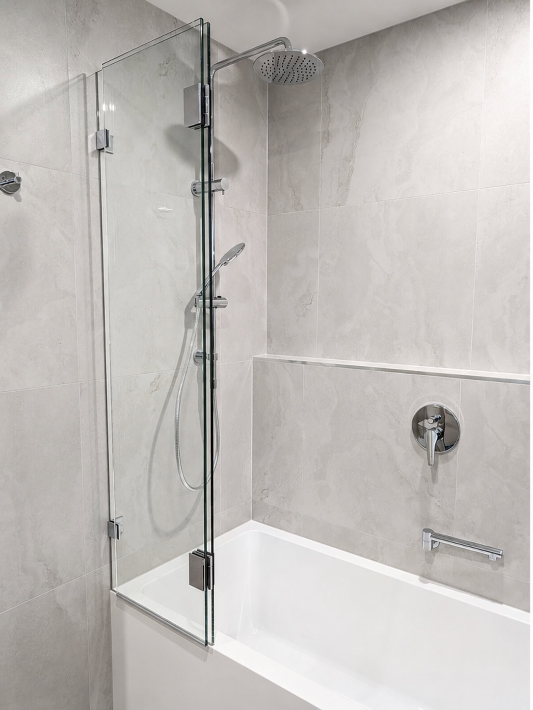 Bi-fold over bath shower screen with folding hinges installed in Bundoora
