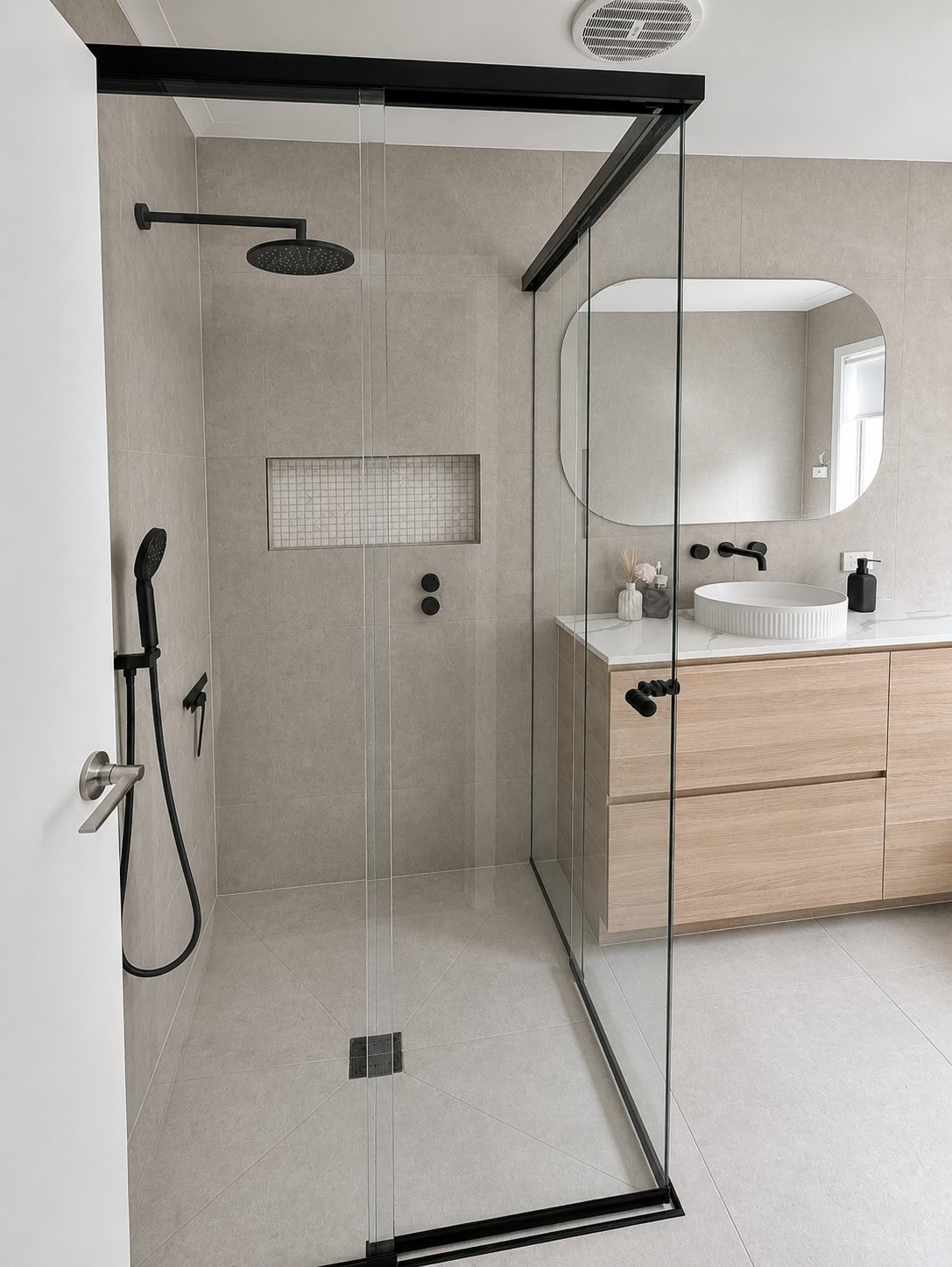 Black corner entry sliding shower screen installed in Derrimut bathroom