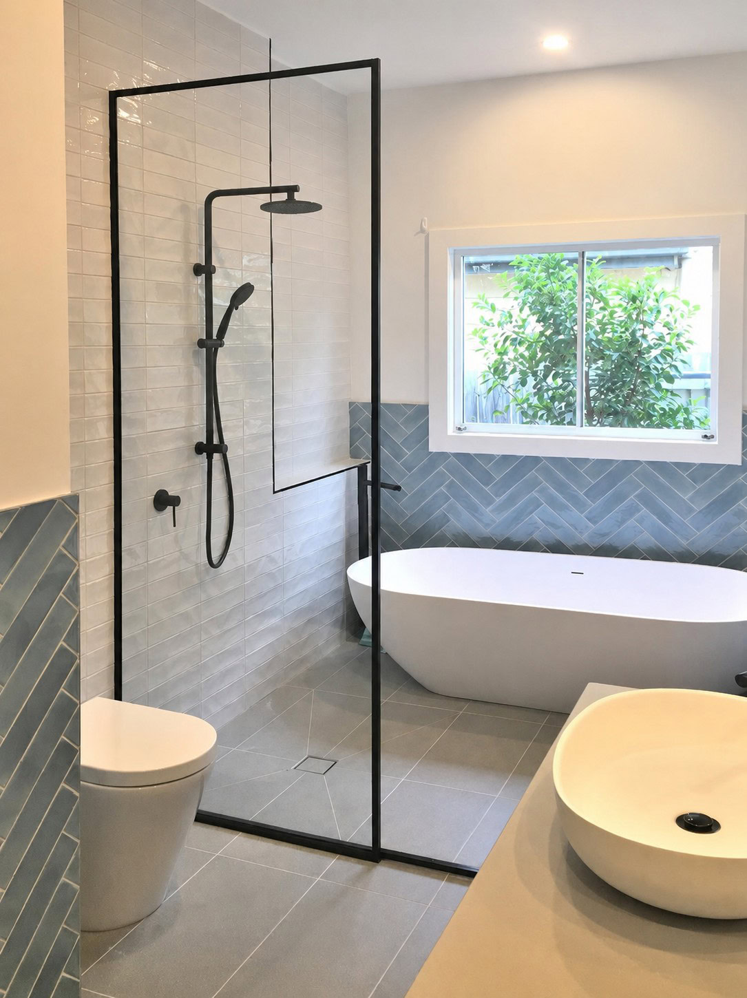 Custom black frame walk in shower screen installed in Kew bathroom