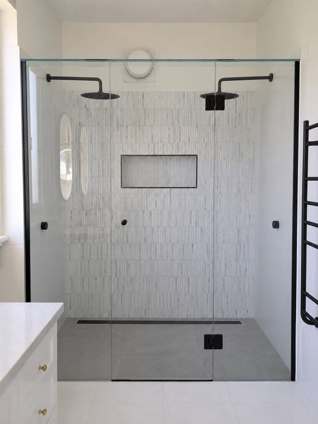 Black frameless shower screen installed in Williamstown bathroom renovation
