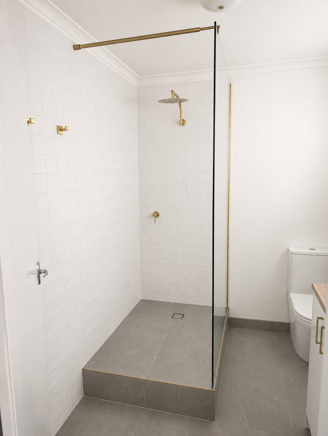 Brushed brass fixed shower panel replacement installed in Clifton Hill