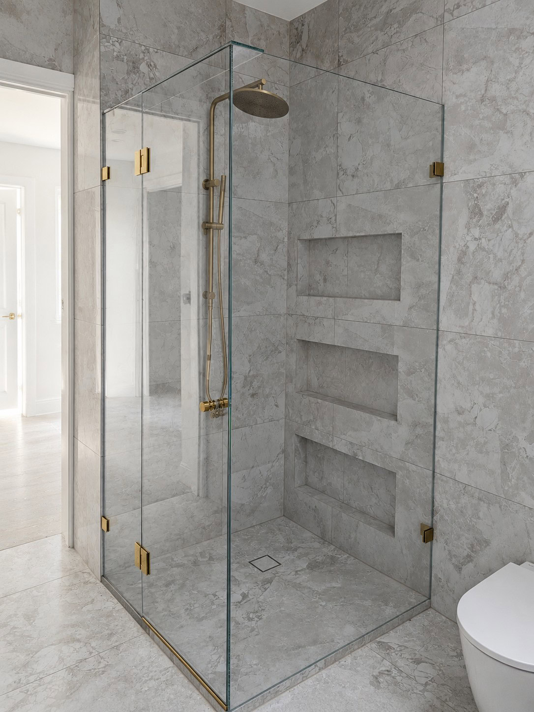 Brushed gold frameless shower screen installed in Armadale