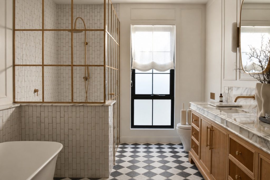 Custom raw brass and low iron glass shower screen in a Point Cook renovation