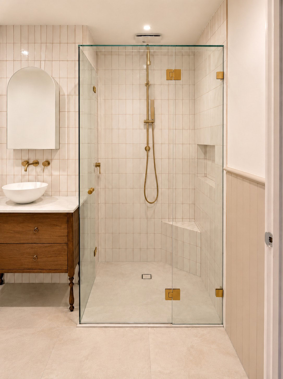 Brushed gold frameless shower screen installed in Greensborough bathroom