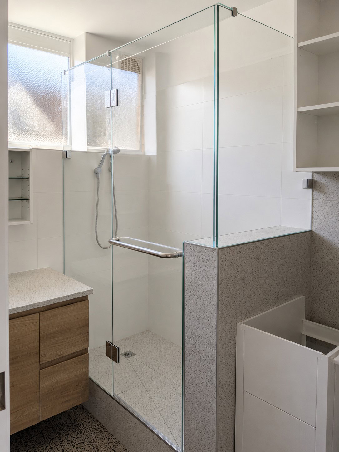Chrome low iron frameless shower screen installed around an existing window in Williamstown
