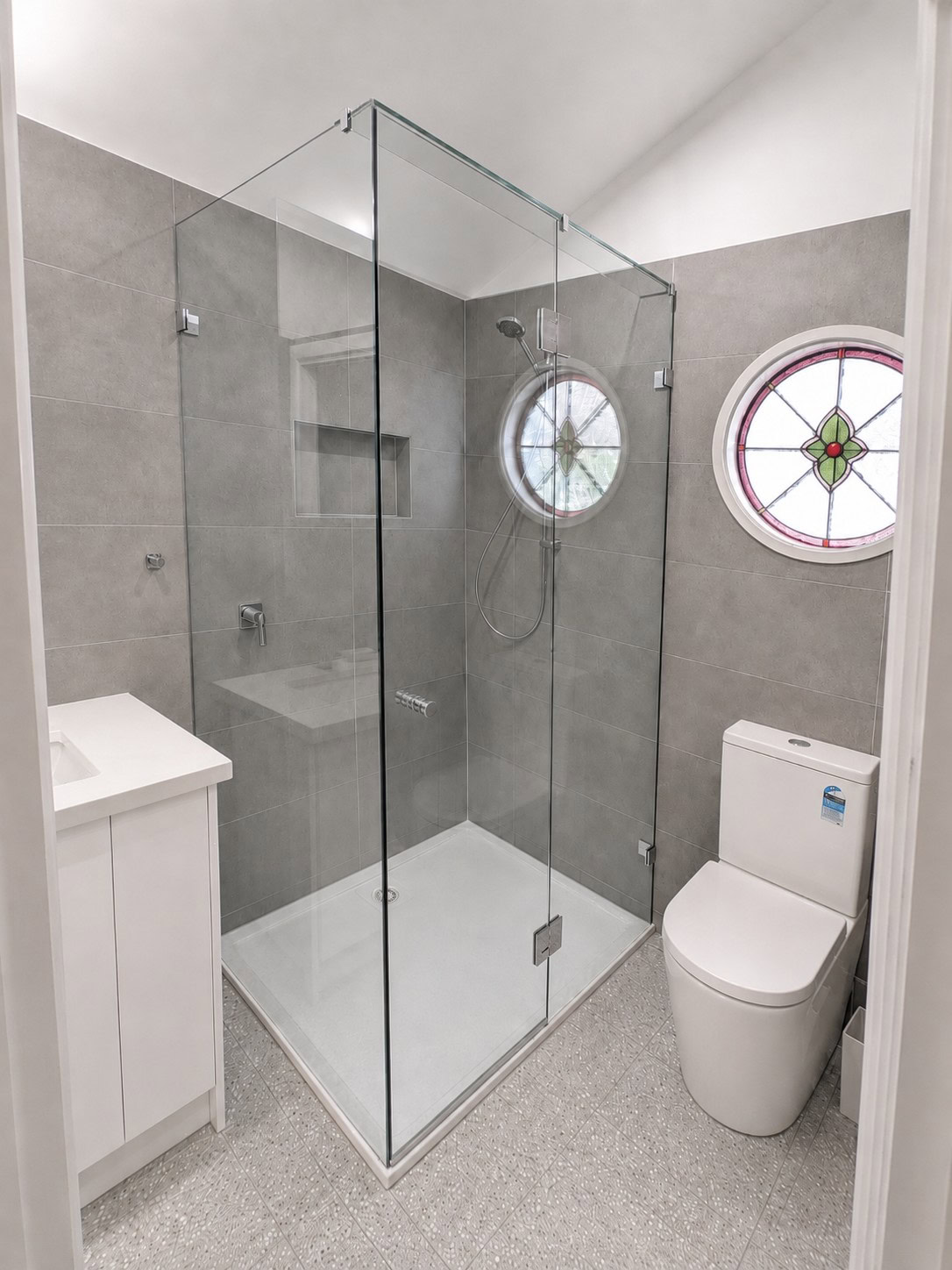 Corner hinged frameless shower screen installed in Essendon