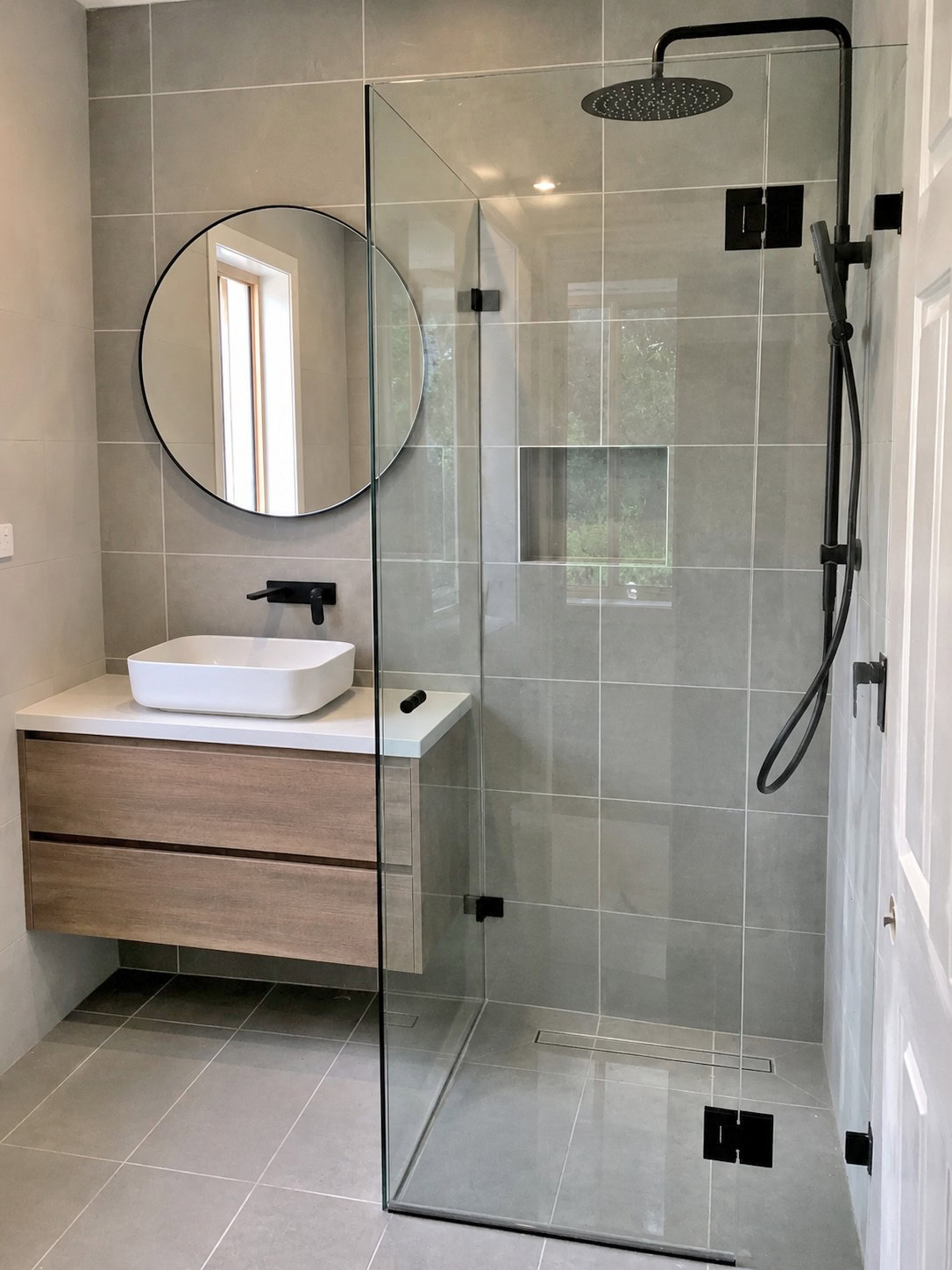 Hinged frameless shower screen in Melbourne bathroom