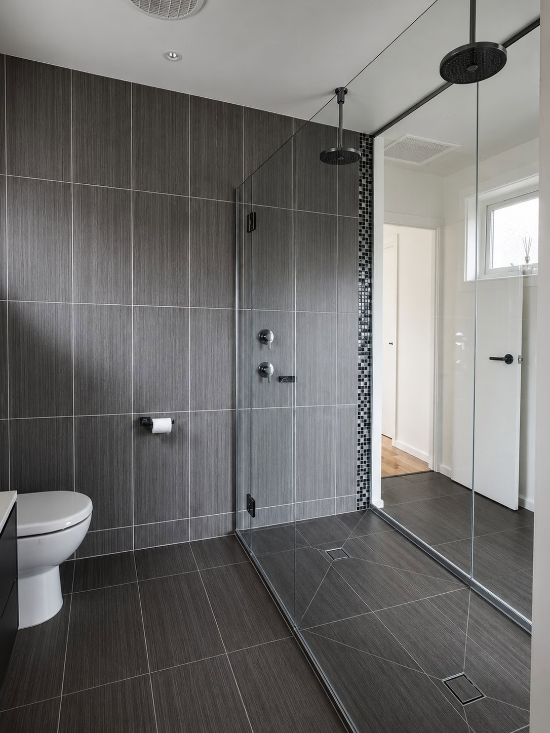 Full-height hinged shower screen installed in Melbourne