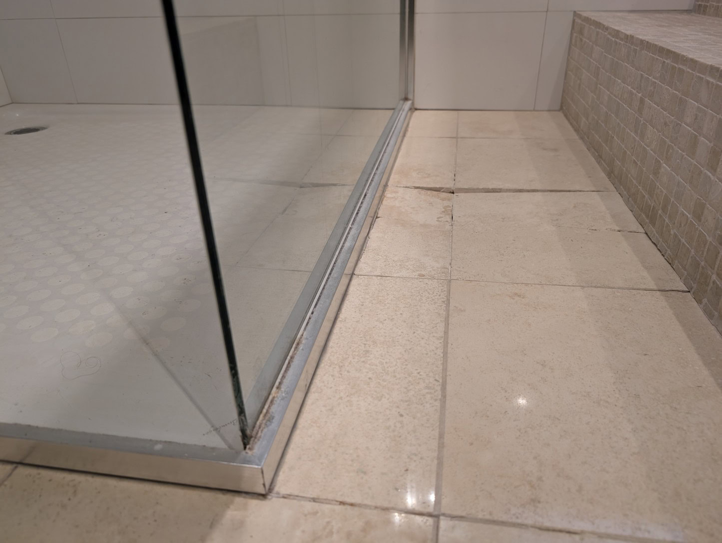 Old framed shower screen removed showing water damaged floor in Avondale Heights