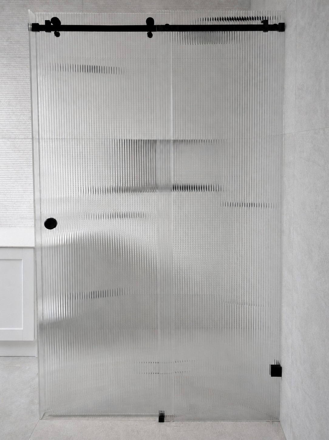 Fluted sliding shower screen installed in Yarraville bathroom