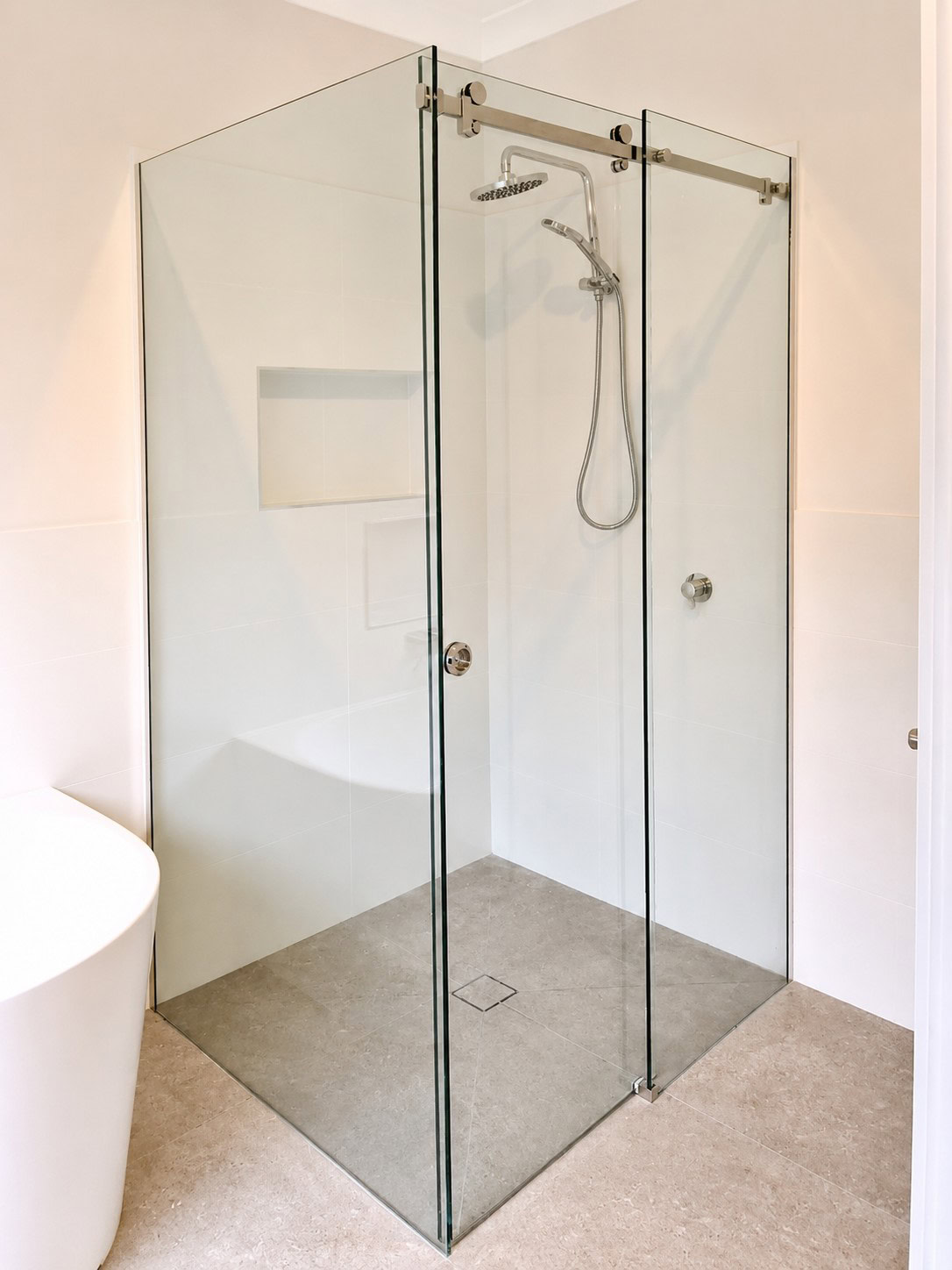Clear glass frameless corner sliding shower screen in a Melbourne bathroom