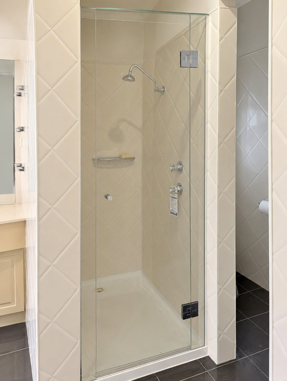 Frameless hinged shower screen installed in Hillside