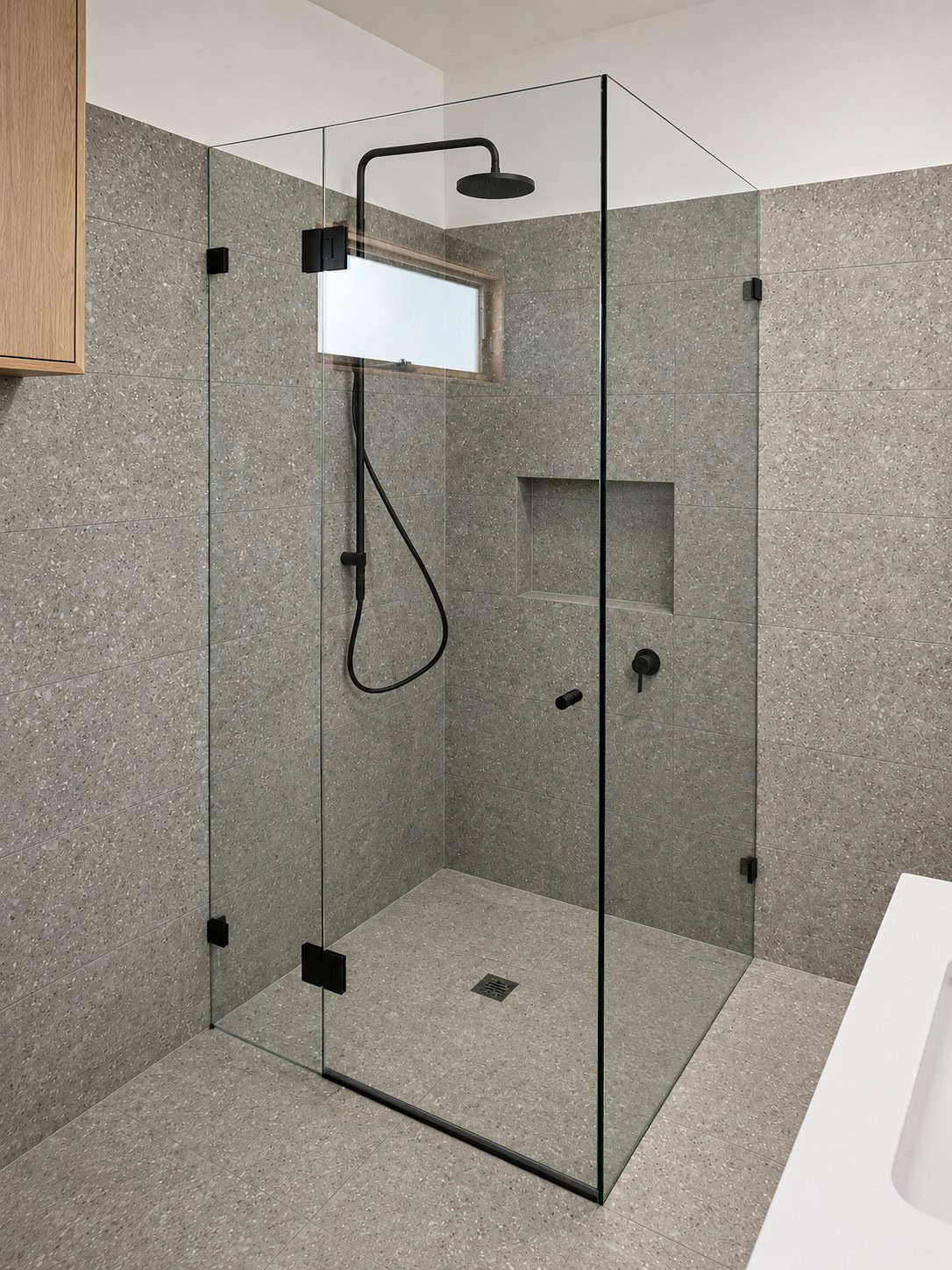 Black frameless shower screen installed in Footscray