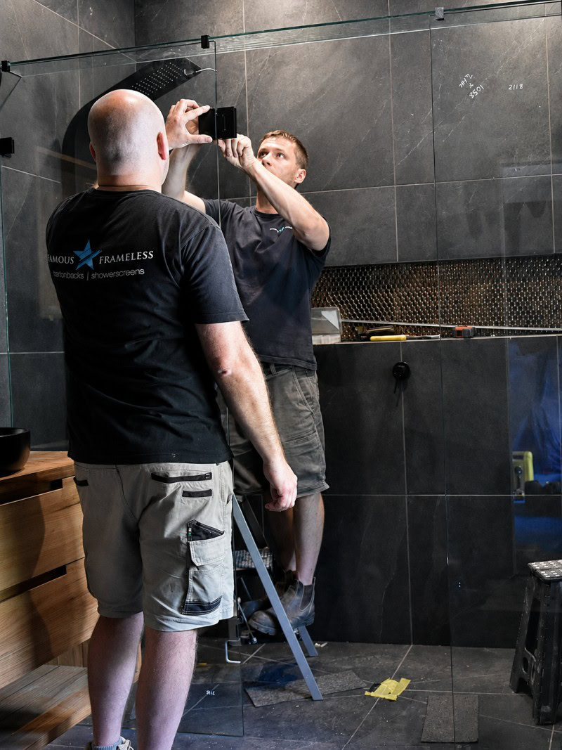 Frameless shower screen installation in progress for a Maddingley bathroom