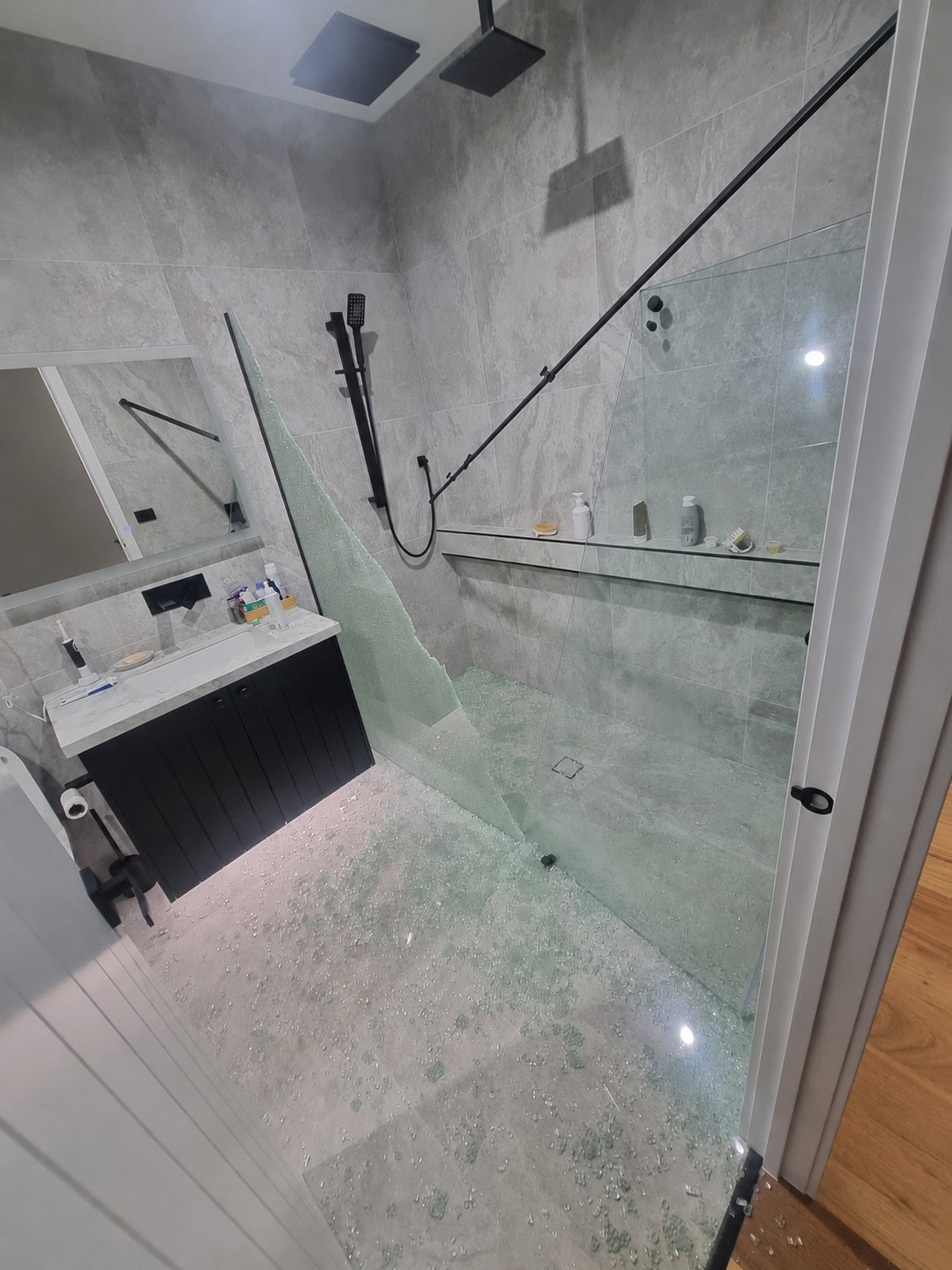 Broken shower screen glass before replacement