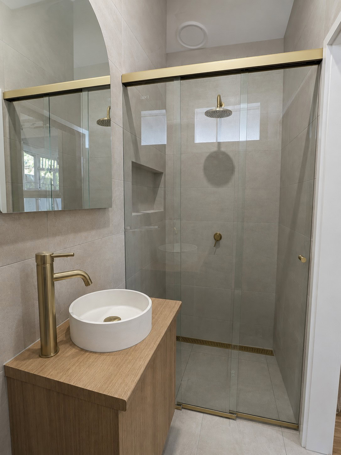 Three panel satin gold sliding shower screen installed in Yarraville bathroom