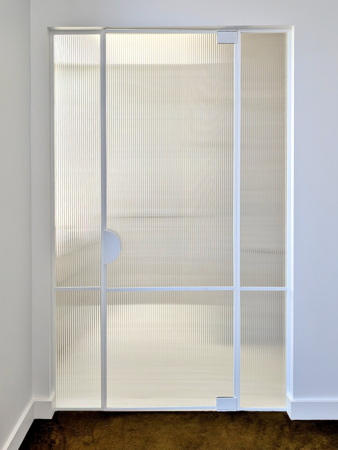 White frame fluted ensuite pivot door installed in Keilor East