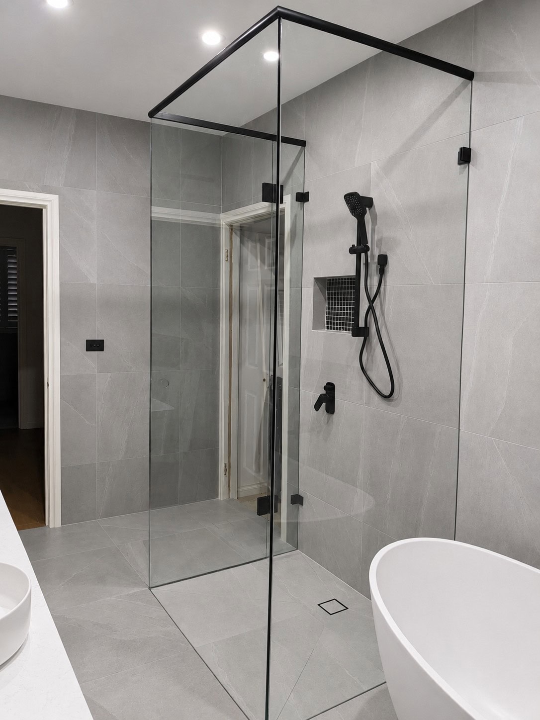 Black three sided shower screen installed in Greenvale bathroom