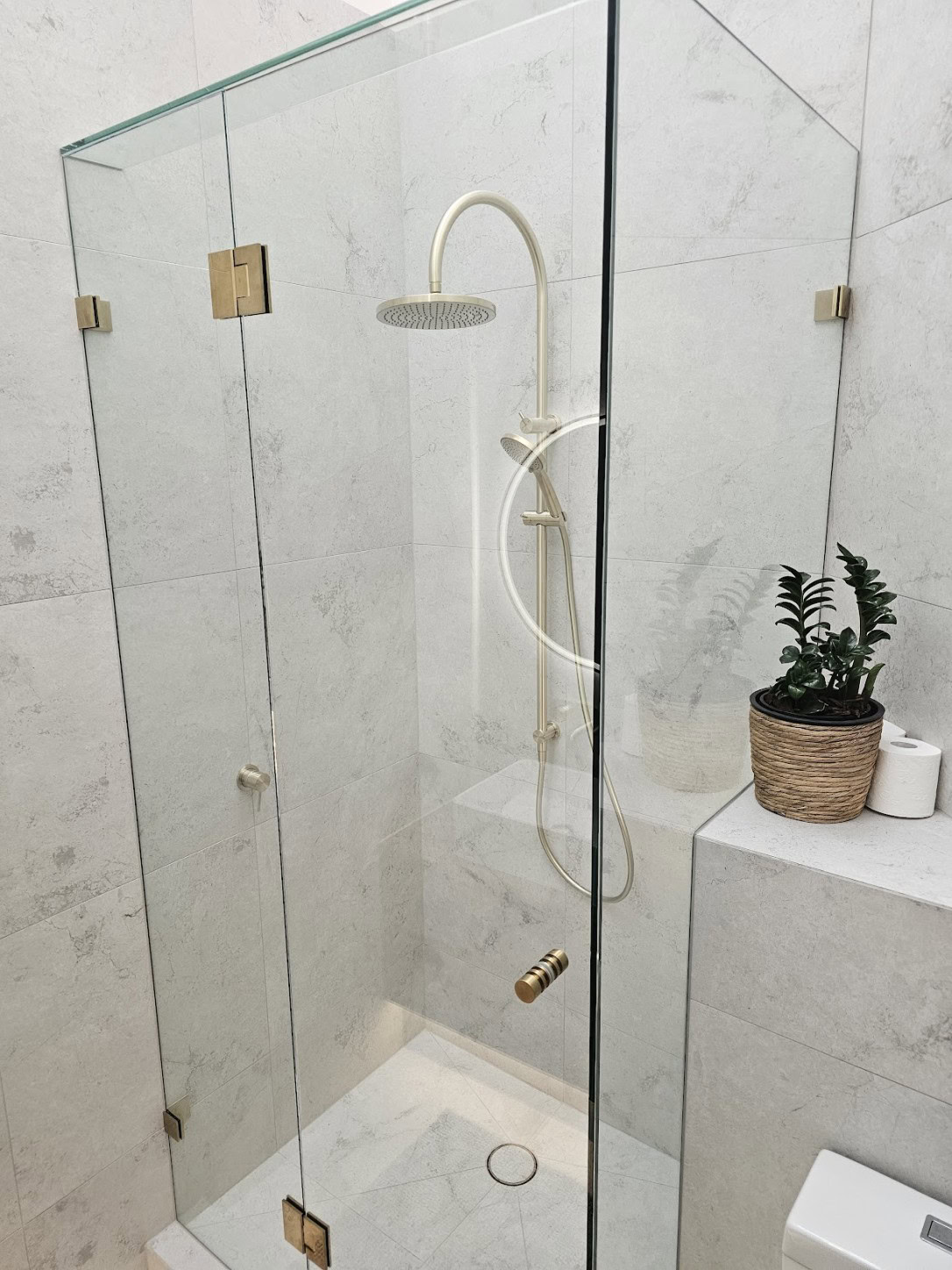 Brushed gold frameless shower screen installed in Keilor Downs bathroom