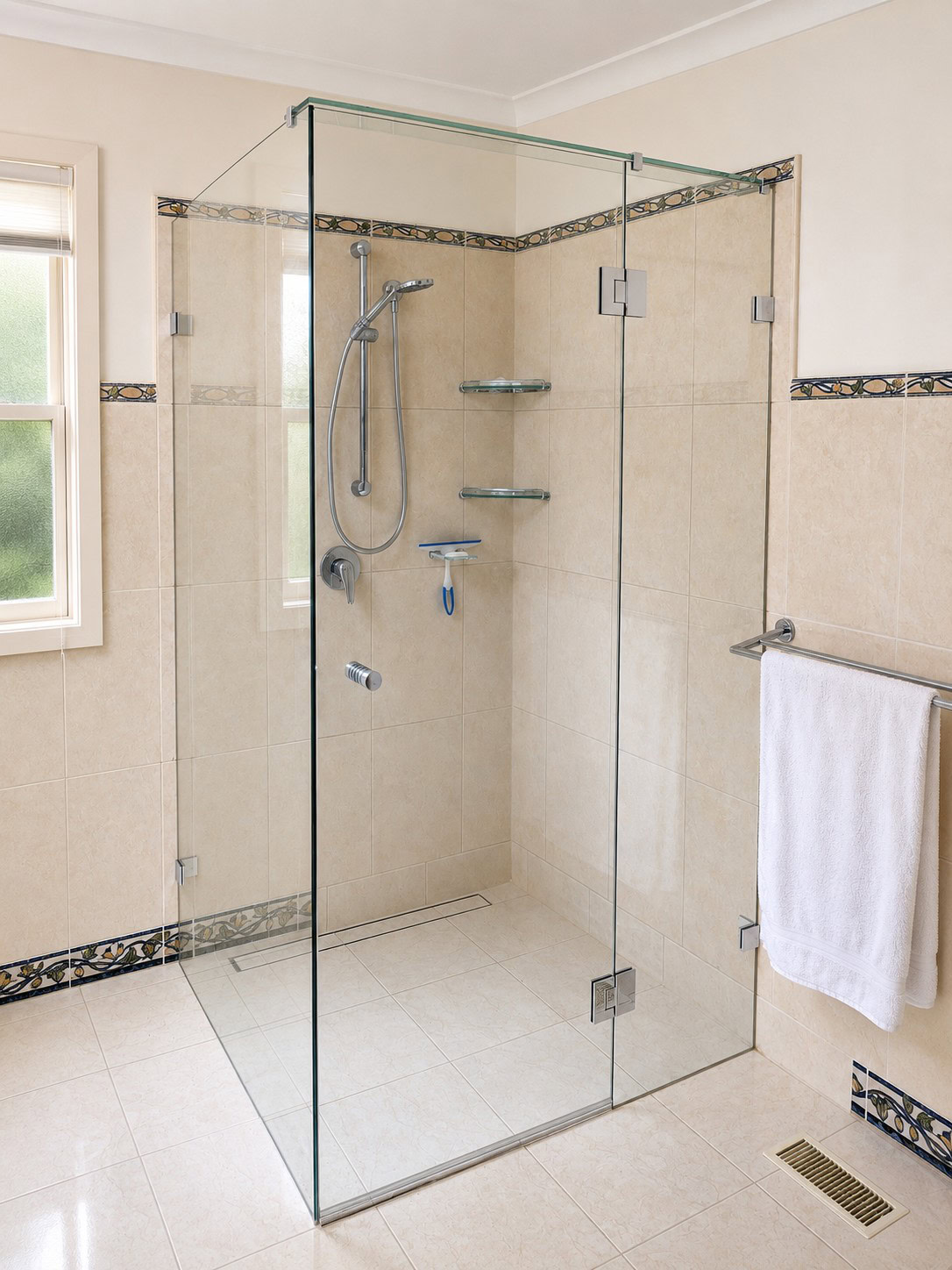 Chrome frameless shower screen with door installed in Eltham bathroom
