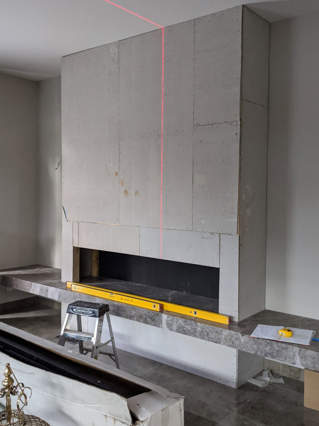 Fireplace before custom bronze mirror installation