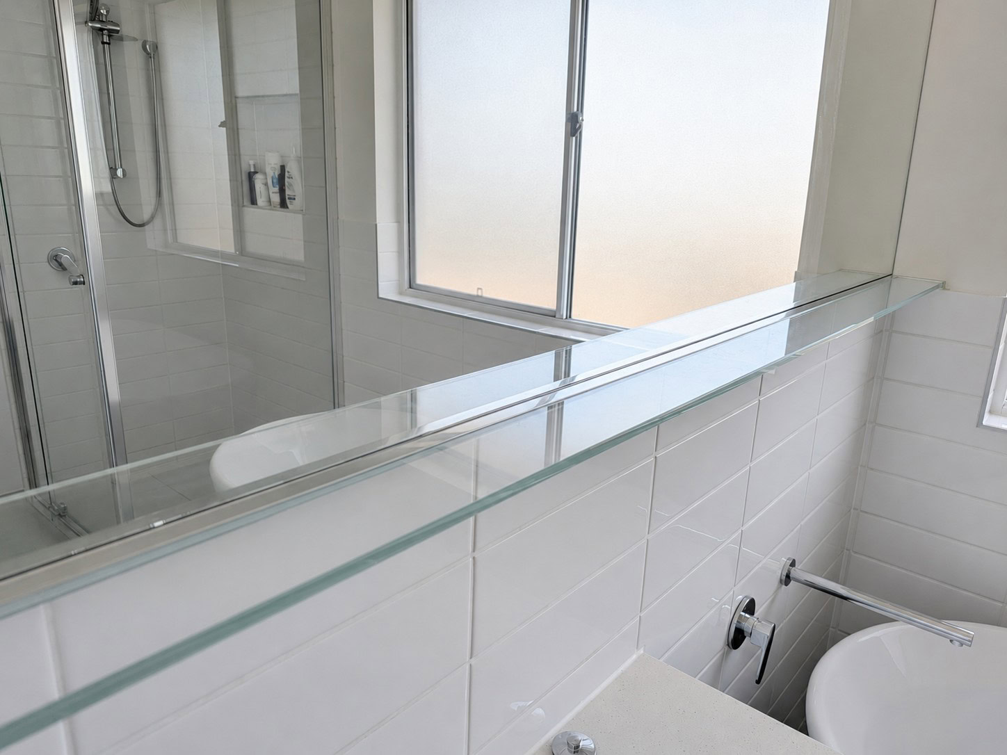 Floating glass shelf installed in Sunbury bathroom