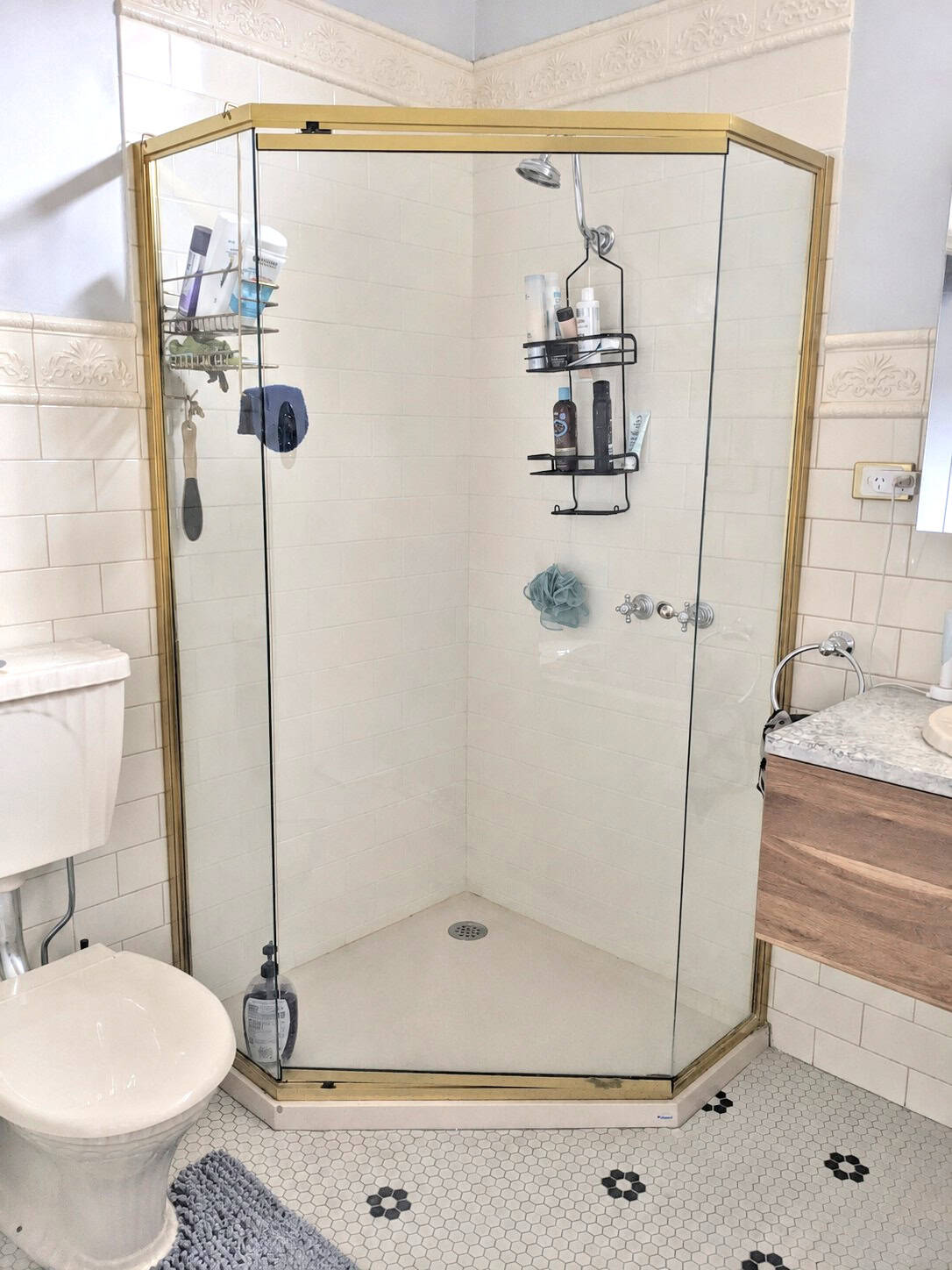 Old framed diamond shape shower screen before replacement in Essendon bathroom