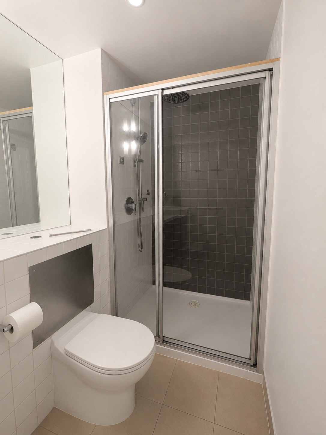 Old pivot door shower screen in Footscray apartment before replacement