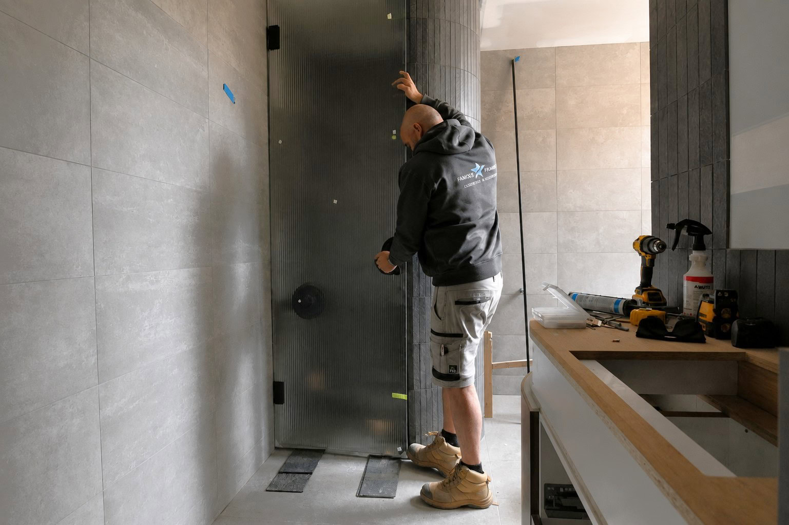 Fluted glass shower door installation in progress in Brighton Melbourne